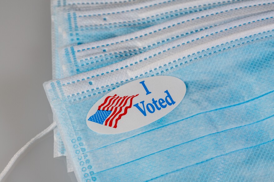 An I Voted sticker on protective face mask for voters casting ballots during coronavirus pandemicic.