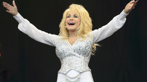 FILE - Dolly Parton performs at Glastonbury music festival, June 29, 2014. (Photo by Jonathan Short/Invision/AP, File)