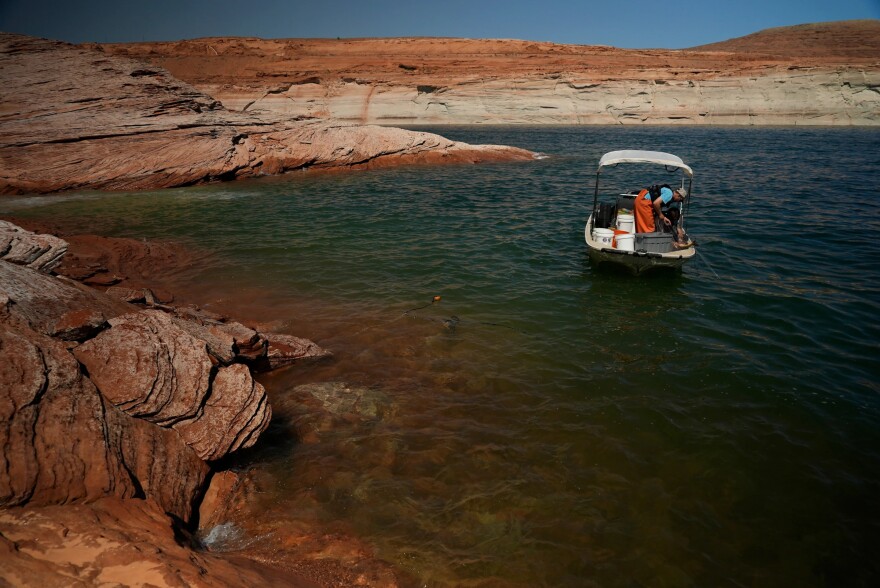 A Utah State University research team works at Lake Powell on June 7, 2022, in Page, Ariz.