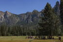 Visitors watch with binoculars for climbers on the face of El Capitan in the heart of Yosemite Valley is seen on June 12, 2026 in Yosemite National Park, California. (Heather Diehl/Getty Images)