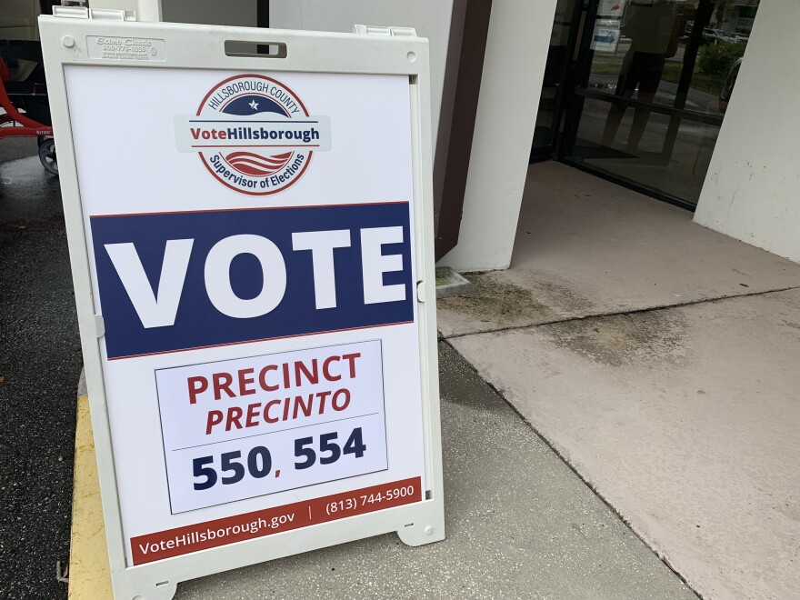 A Vote placard in front of a precinct building.