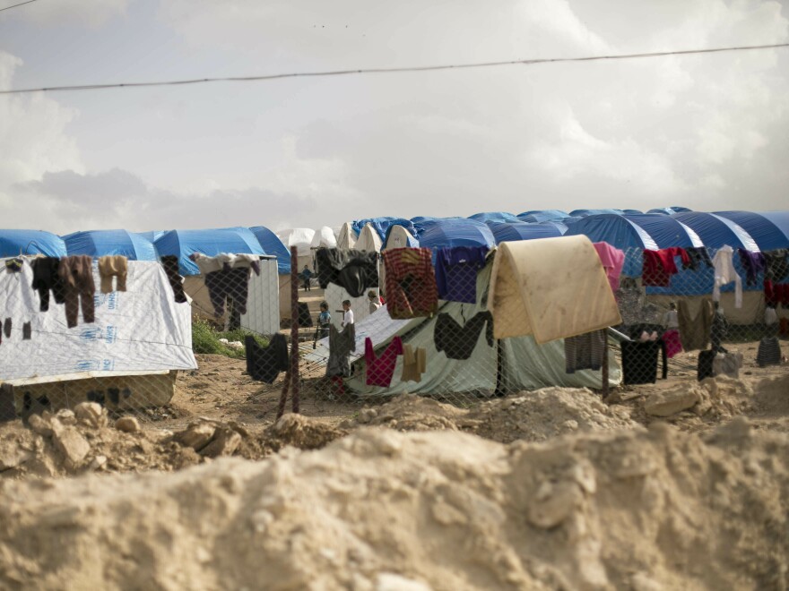 Laundry dries on a chain link fence in an area for foreign families of suspected ISIS fighters at al-Hol camp in Hassakeh province, Syria.