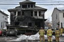 Firefighters from the Kingston Forty Fort Fire Department observe the scene of a fatal fire on N. Welles Street in Kingston.