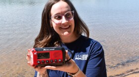 Corrine Rizzo from Charlotte-Mecklenburg Storm Water holds up an emergency radio.