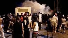Police fire tear gas into the protest on Tuesday night
