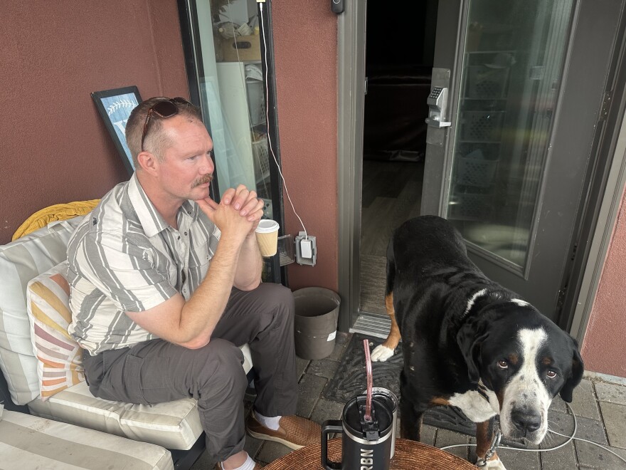 Aspen Fire Chief Jake Andersen takes a break on his back porch near the Aspen Airport Business Center on July 9, 2026. His dog, affectionately named “Tug Boat,” keeps him company.