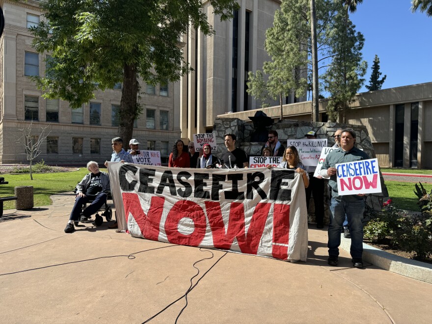 People hold sign reading "Ceasefire now"