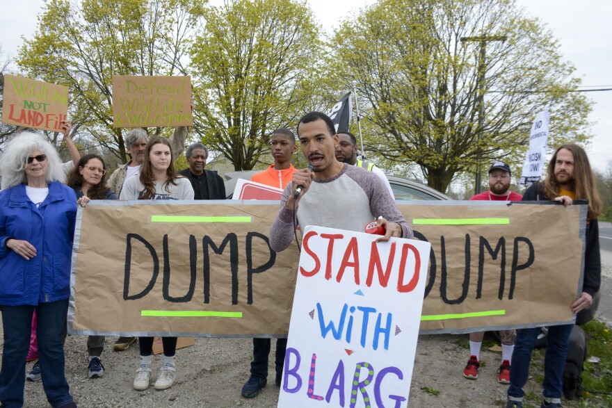 Ezekiel Torres, of Shirely, stands with the Brookhaven Action and Remediation Group (BLARG) during an Earth Day rally on April 22, 2023, for transparent waste management on Long Island.