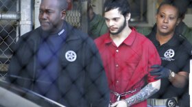 Jan. 30, 2017, Esteban Santiago, center, is led from the Broward County jail for an arraignment in federal court in Fort Lauderdale, Fla. Federal prosecutors on Monday, May 21, 2018, filed court documents in which agrees to plead guilty to a Florida airport shooting rampage that killed five people and wounded six last year. The agreement filed Monday says that 28-year-old Santiago will plead guilty to 11 of the 22 counts against him. Prosecutors reached a deal with Santiago’s defense lawyers not to seek the death penalty in exchange for the guilty plea. Instead, Santiago would serve a life prison sentence. (AP Photo/Lynne Sladky, File)