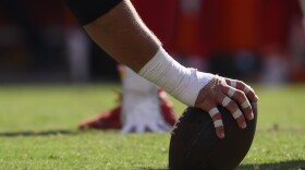 A Detroit Lions player grips an NFL football during a game against the Kansas City Chiefs, Saturday, Aug. 17, 2024 in Kansas City, MO.