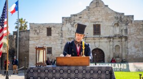 Reenactor Sam Haynie reads aloud from the famous "Travis Letter" written by Alamo Commander William Barret Travis, which called for outside aid to come to the surrounded fortress