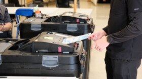 A voter enters their ballot into a counting machine during the state primary election Sept. 8, 2026 at Oyster River High School in Durham, NH.