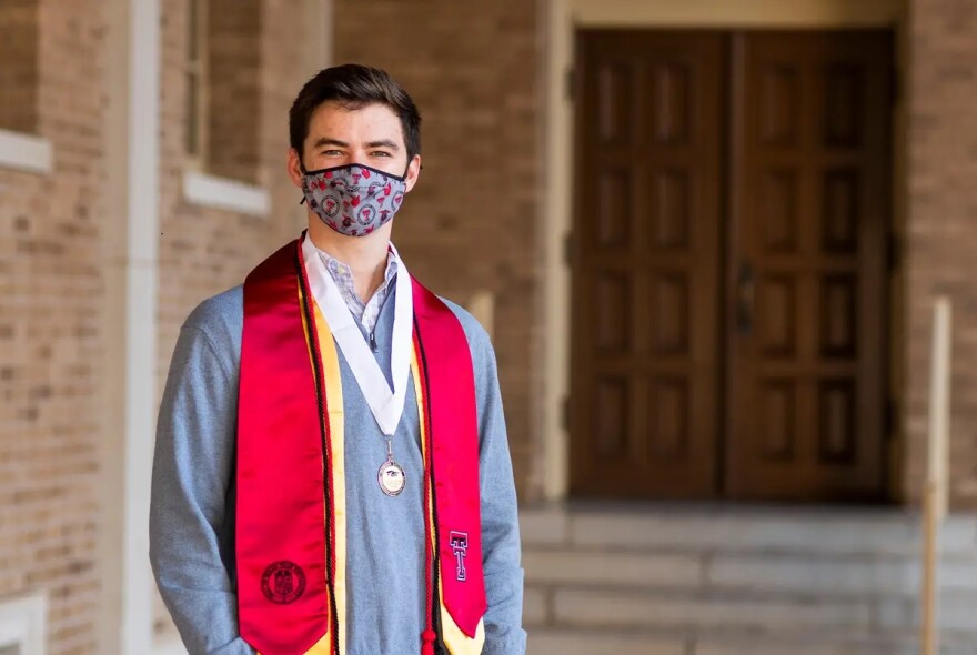 Klay Davis poses with his graduation stolls and a medal. 