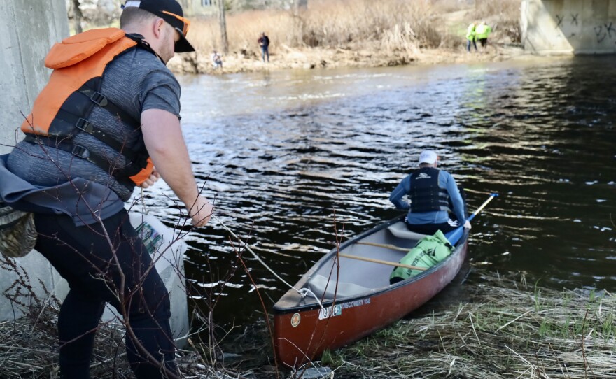 Two participants get ready to launch their boat for the race.