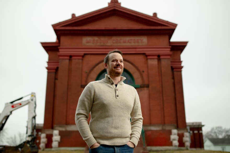 A white man stands in front of Missouri's first crematorium.