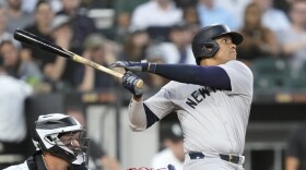 New York Yankees' Juan Soto watches his two-run home run off Chicago White Sox starting pitcher Jonathan Cannon during the third inning of a baseball game Tuesday, Aug. 13, 2024, in Chicago. (AP Photo/Charles Rex Arbogast)