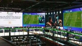 A massive 2,000-square-foot television wraps around the DraftKings Sports Bar at Wrigley Field.