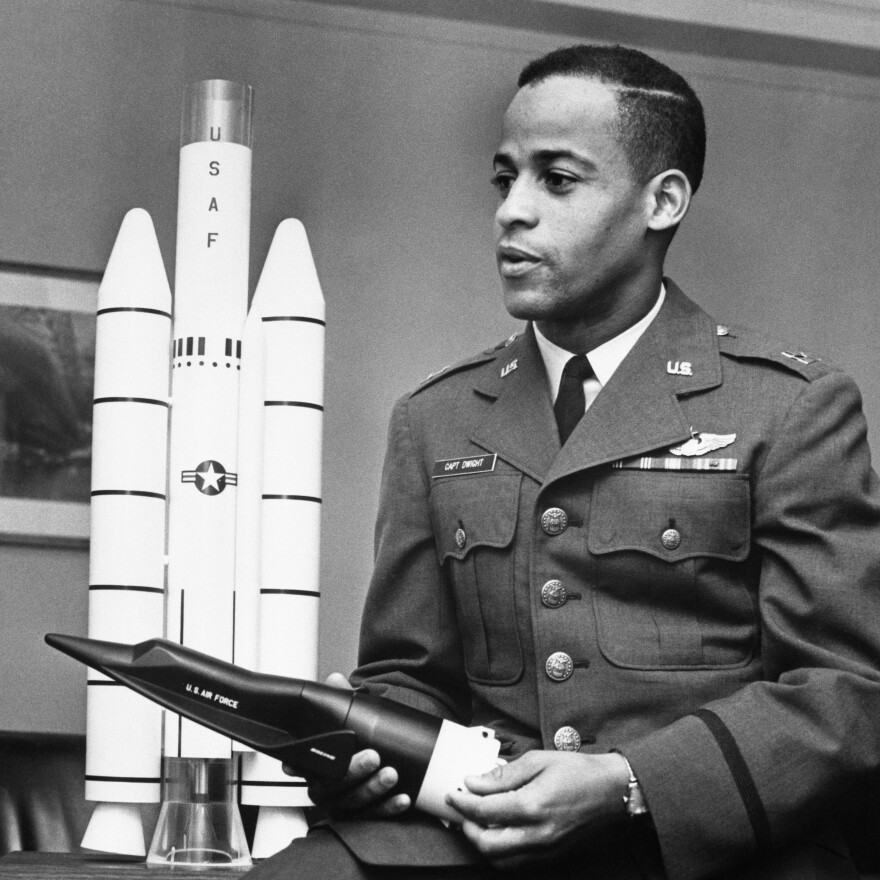 Air Force Capt. Edward J. Dwight Jr., the first African American selected as a potential astronaut, looks over a model of the Titan III-X-20 Dyna-Soar combination during a visit to Air Force headquarters in the capital in November 1963.