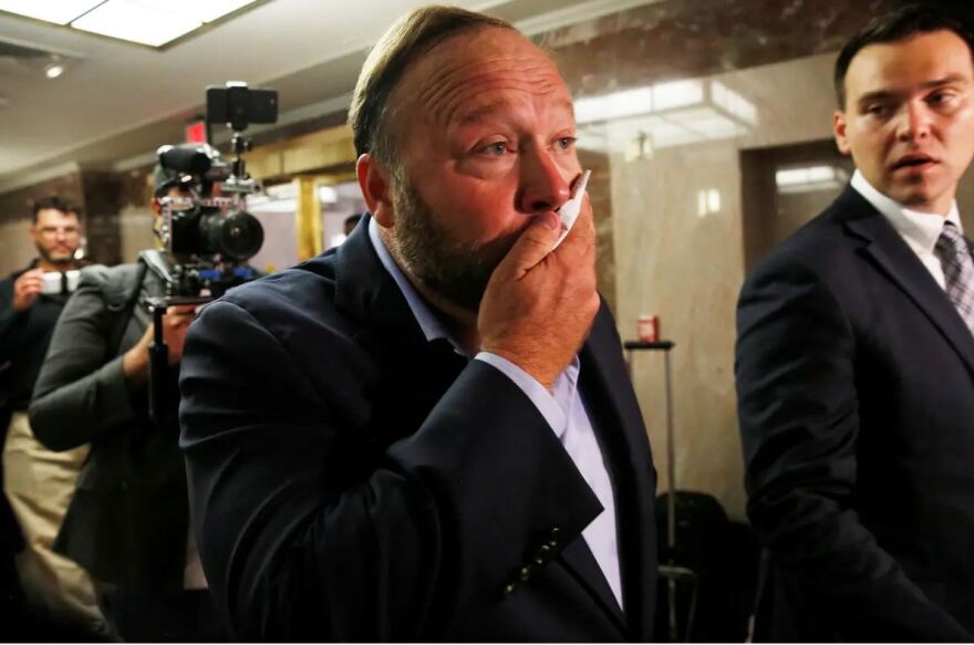 Jones wipes his face after talking to the press as he walks into a Senate Intelligence Committee hearing in September 2018 to listen to Jack Dorsey, then the CEO of Twitter, and Facebook COO Sheryl Sandberg testify on foreign influence operations on social media platforms.