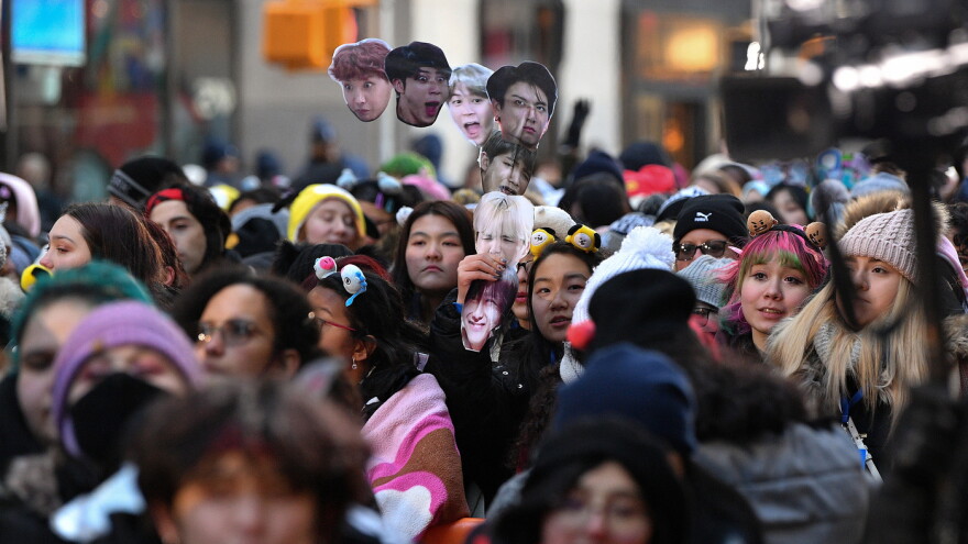 Crowds outside The Today Show in New York holding BTS signs.