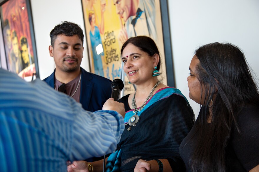 Director of "Falafel" Nikita Hattangady speaks to an interviewer at the red carpet event. "Falafel" is a romantic comedy following two protagonists in London as they power through a terrible day.