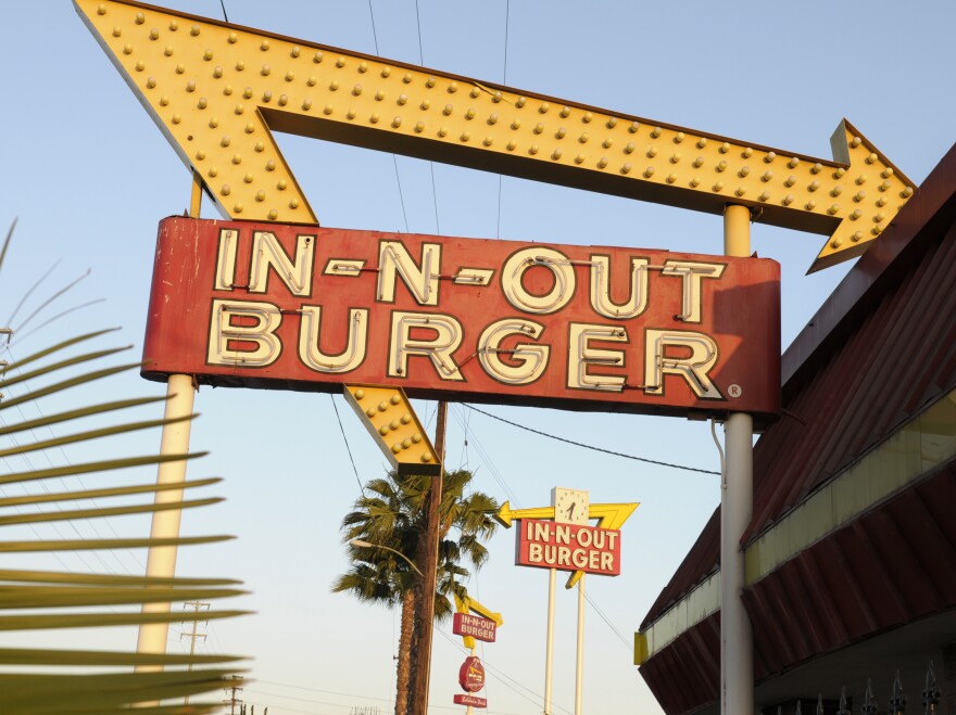 In-N-Out Burger signs fill the skyline on Tuesday, June 8, 2010, in Calif. The In-N-Out hamburger chain is sizzling mad after San Francisco shut down its indoor dining for refusing to check customers’ vaccination status. The company's Fisherman’s Wharf location — its only one in San Francisco — was temporarily shut by the Department of Public Health on Oct. 14. (AP Photo/Adam Lau)