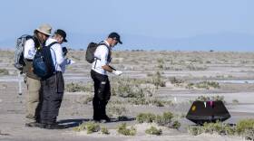 In this handout provided by NASA, The sample return capsule from NASA's OSIRIS-REx mission landed at the Department of Defense's Utah Test and Training Range. (Keegan Barber/NASA via Getty Images)