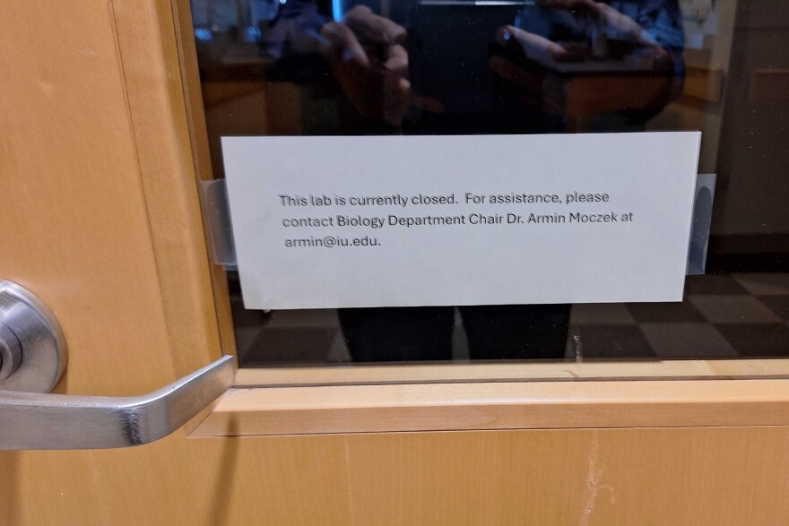 Image of a door with a note on it informing the reader that the lab is currently closed