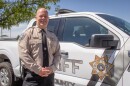 Weber County Sheriff Ryan Arbon stands next to a patrol vehicle outside the sheriff's office in Ogden, Aug. 25, 2026