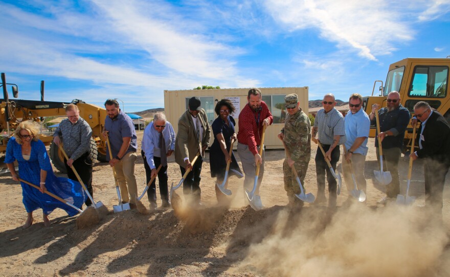 District One leadership and community partners break ground. Behind them stands a mobile office constructed by Fourth Avenue Junior High students in Dr. David Cullison's construction class. The office will be used by Pilkington during construction.