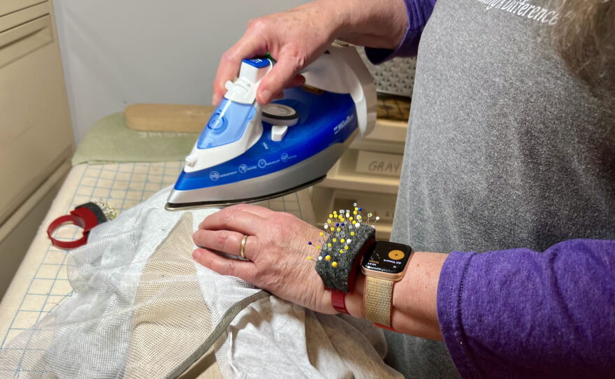 Pat Cochran presses a seam in preparation to add a zipper. She said the process of transforming shirts only takes her just 15 minutes.