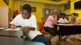 A boy does his homework at one of the Bethany House shelters.