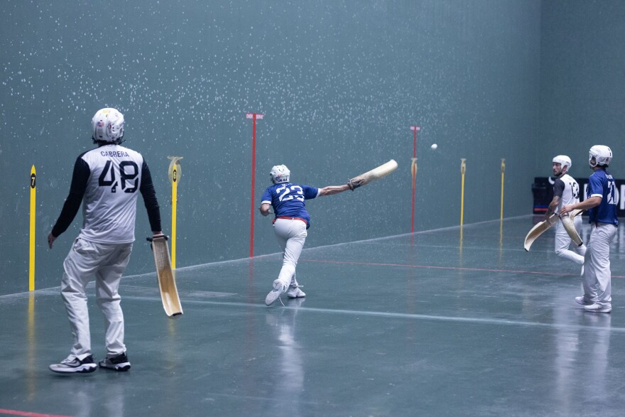 Players throw the ball from a basket-like tool called a "cesta" toward the far wall at upwards of 100 miles per hour.