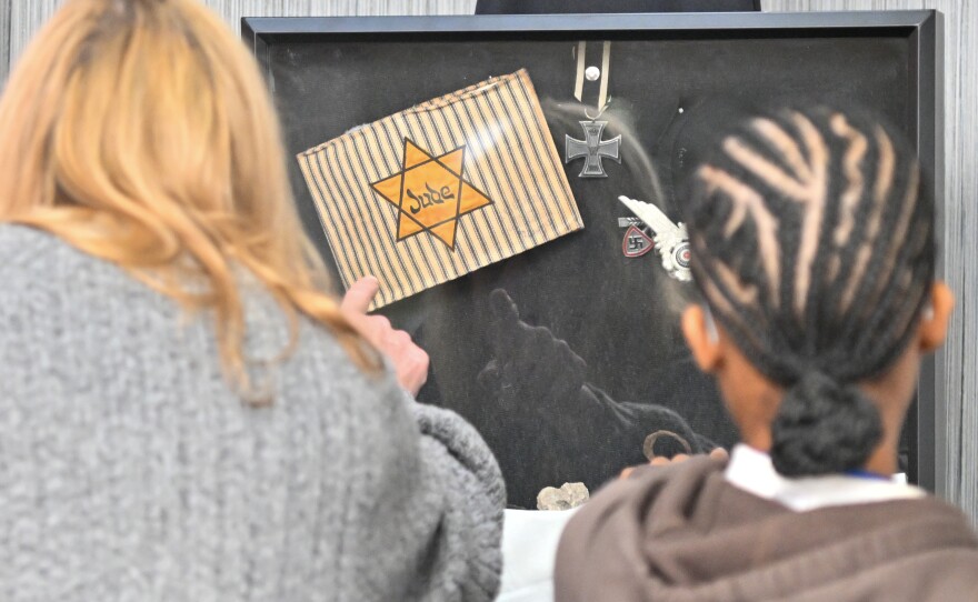 Teacher Leslie Kotcho and her student, sophomore Shaliyah Brown, look at Holocaust artifacts.