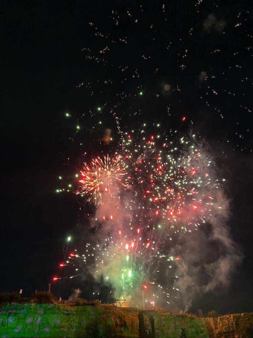 Fireworks launched from a cliff overlooking Fiesta Texas