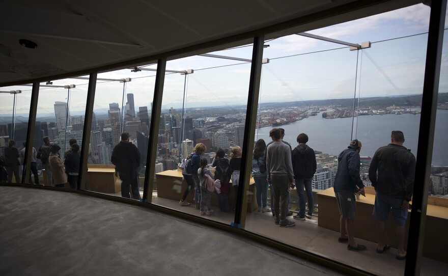 People gather on the observation deck of the Space Needle  on Tuesday, June 5, 2018, in Seattle.