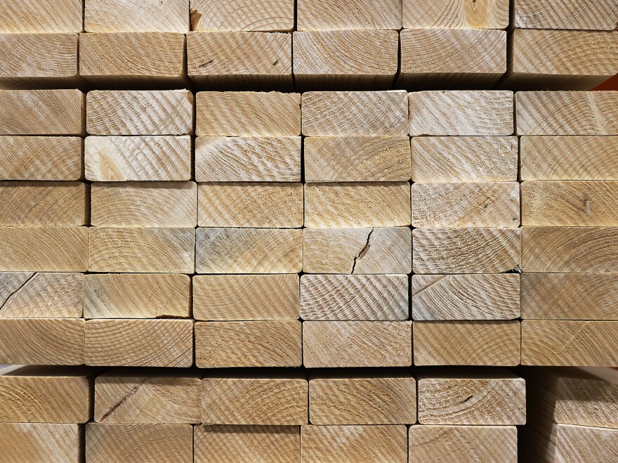 Lumber is stacked up for sale at a Home Depot store in May in Doral, Fla. Lumber prices surged during the pandemic, only to fall as the economy started to open up again. But prices remain volatile and still more expensive than pre-pandemic levels.
