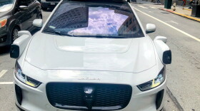 A Waymo autonomous vehicles drives through downtown San Francisco