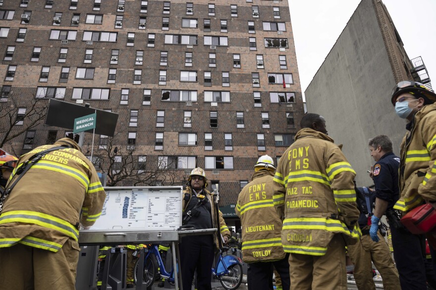 Firefighters work at the scene of a fatal fire at an apartment building in the Bronx on Sunday. (Yuki Iwamura/AP Photo)