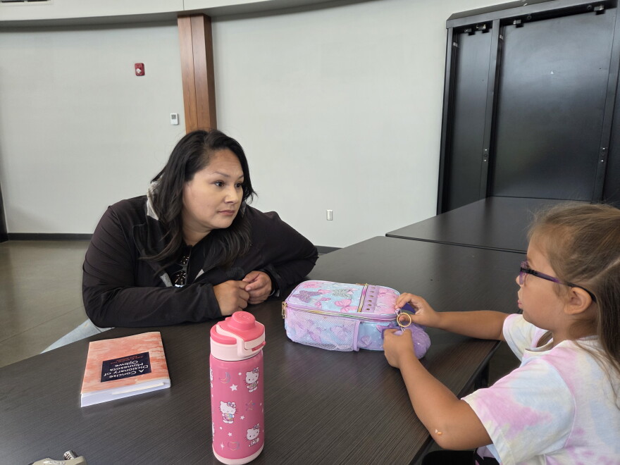 Chelsey Jourdain, a cultural educator at Endazhi-Nitaawiging, visits with a student after a ribbon-cutting ceremony at the school on Aug. 25, 2026.