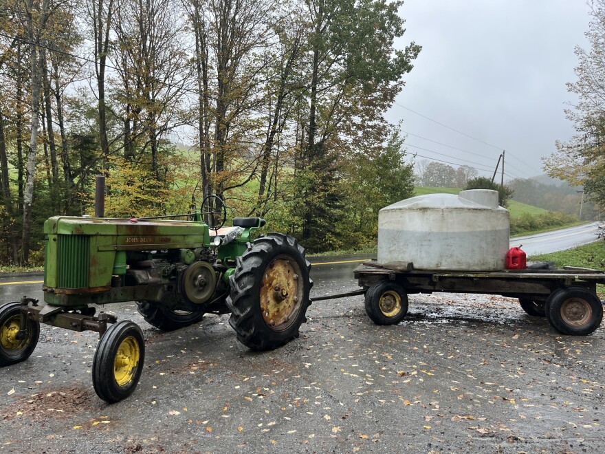 A water tank sits on a tractor trailer bed.