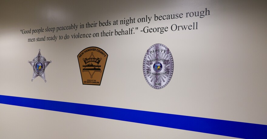 A newly repainted hallway in the New Hanover County Sheriff's Office features a host of inspirational quotes, including this one, which is not from George Orwell.