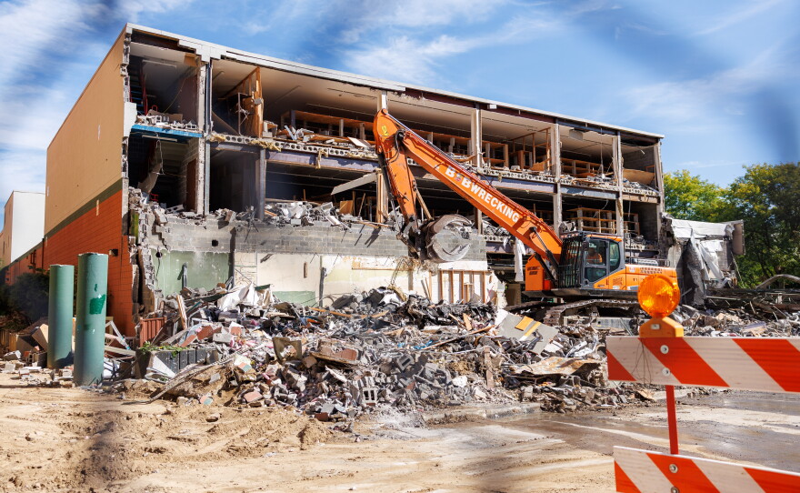 Demolition crews tear down the former Spartan Bookstore in East Lansing, Mich., on Sept. 14, 2026. A new apartment high-rise will be built on the site.