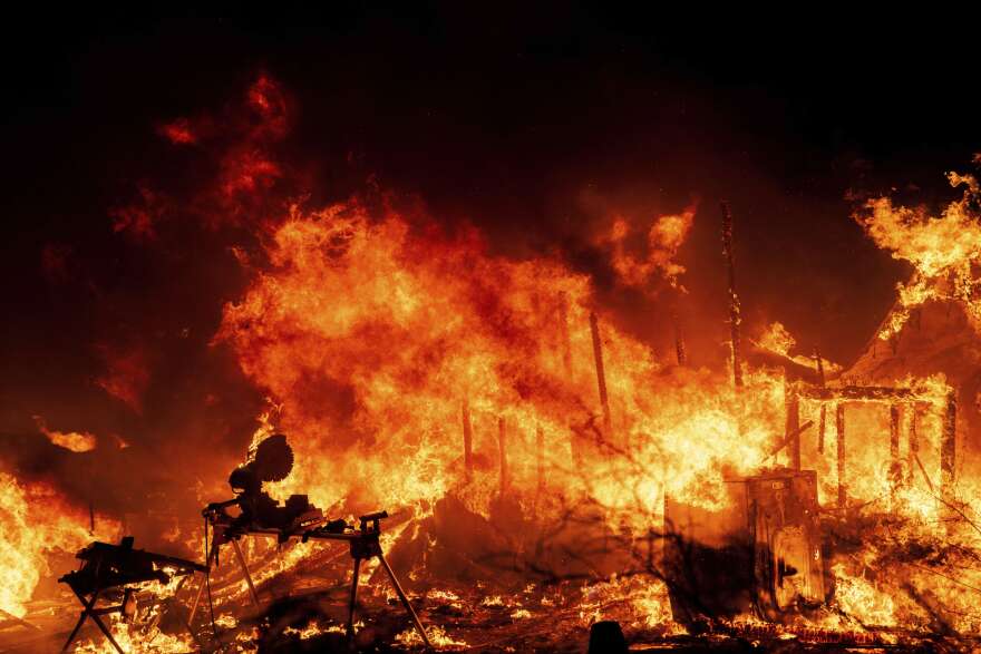 A structure is engulfed in flames as a wildfire called the Highland Fire burns in Aguanga, Calif., Oct. 30, 2023. FEMA announced Jan. 19, 2024, it is making changes to its program that helps those who survive wildfires, hurricanes and other natural disasters. 