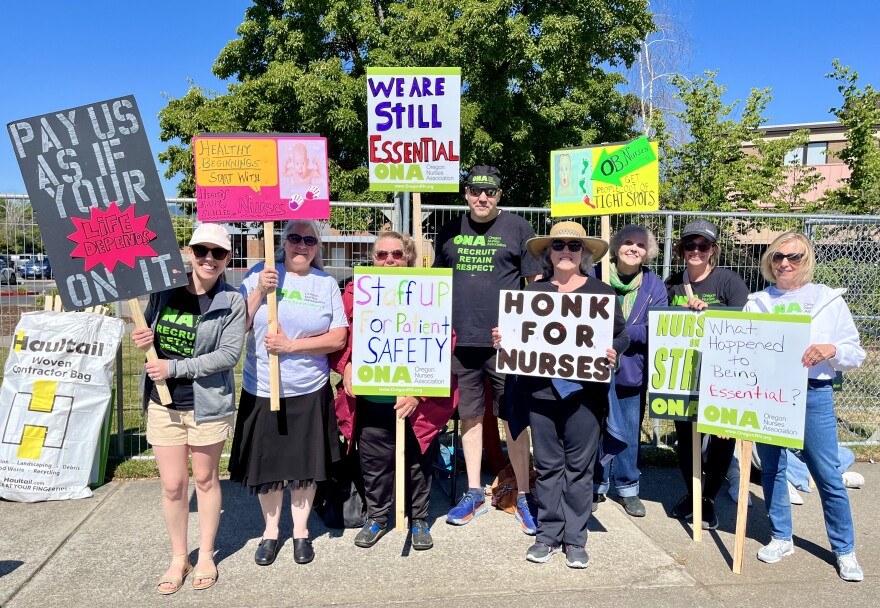 Strikers with signs outside Providence Medford Medical Center on June 18, 2024.