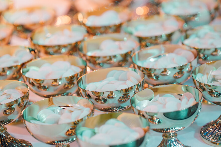 Thousands of Communion hosts are prepared ahead of the beatification Mass for the late Archbishop Fulton J. Sheen on Thursday at the Dome at America's Center in downtown St. Louis.