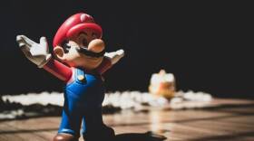 A Super Mario toy figure - Cláudio Luiz Castro