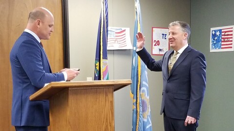 Kansas secretary of state Scott Schwab swears in Fred Sherman as Johnson County's election commissioner in 2021.