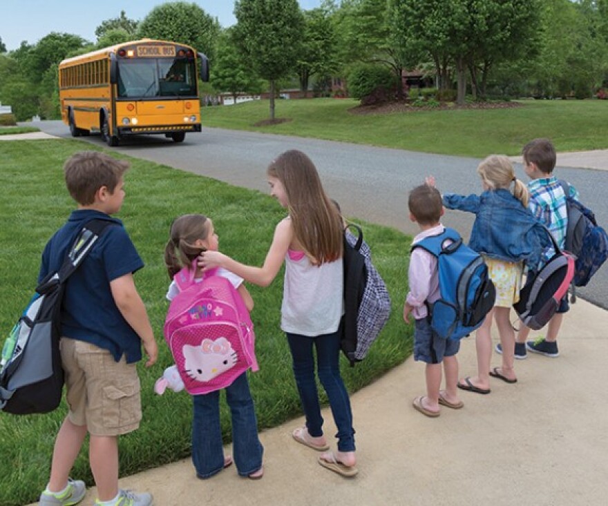 School children waiting to get on their electric bus