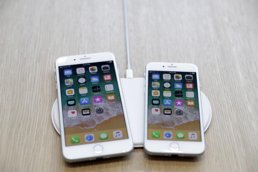 The AirPower wireless charger and iPhones are displayed in the showroom after the new product announcement at the Steve Jobs Theater on the new Apple campus in Cupertino, Calif.,  Sept. 12, 2017. (Marcio Jose Sanchez, File/AP)